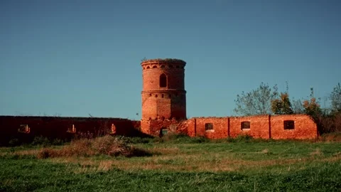 Ancient brick tower surrounded by ruins in nature Stock Footage 301125154