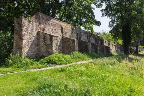An ancient brick wall structure, part of old city fortifications, stands amid Stock Photos
