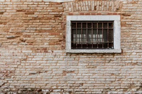 Ancient brick wall texture. Window with grill and railings. Venice italy Stock Photos