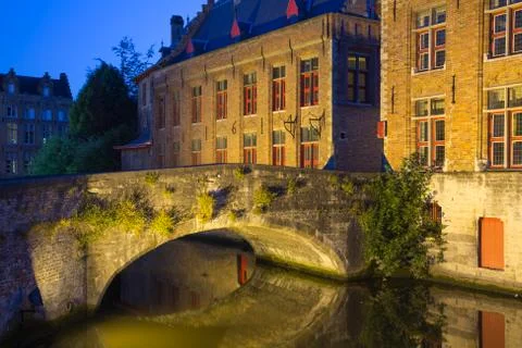 Ancient bridge at Dijver Canal in Bruges at night. (Belgium) Stock Photos