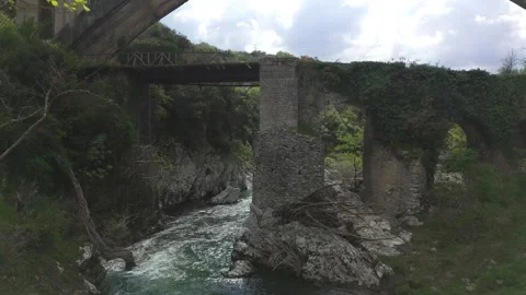 Ancient Bridge Ruins Under Modern Arch Bridge in Peloponnese Stock Footage 337087013
