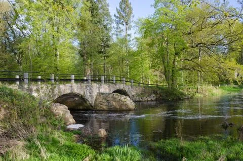Ancient bridge at small river Stock Photos