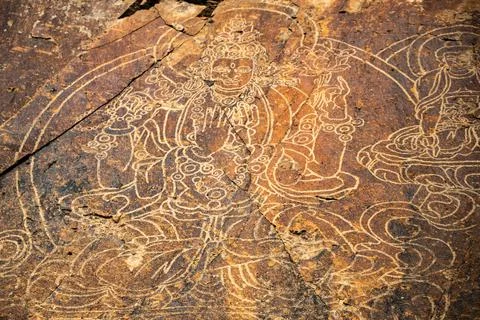 An ancient Buddha image on a stone rock. UNESCO World Heritage Site Stock Photos