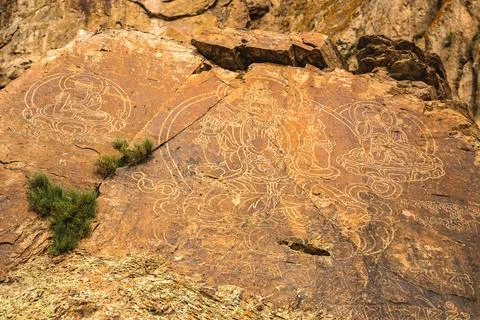 An ancient Buddha image on a stone rock. UNESCO World Heritage Site in Almaty Stock Photos