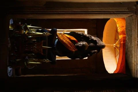 Ancient buddha statue in an old temple in golden traditional clothes. Stock Photos