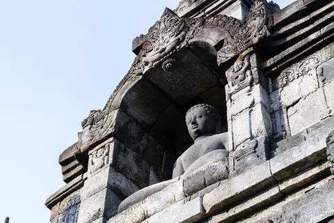 Ancient buddha statue sitting inside borobudur temple in java, indonesia Stock Photos
