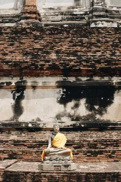 Ancient Buddha statues placed on brick walls in Thai temples. Stock Photos