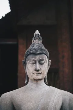 Ancient Buddha statues placed on brick walls in Thai temples Stock Photos