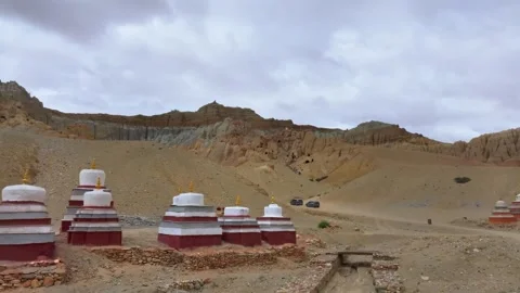 Ancient Buddhist Chortens and Cave Dwellings in Arid Tibetan Landscape Tibet Stock Footage 346585097