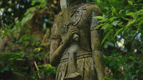 Ancient Buddhist Stone Statue Holding Sword in Tropical Jungle, Traditional Stock Footage 327796551