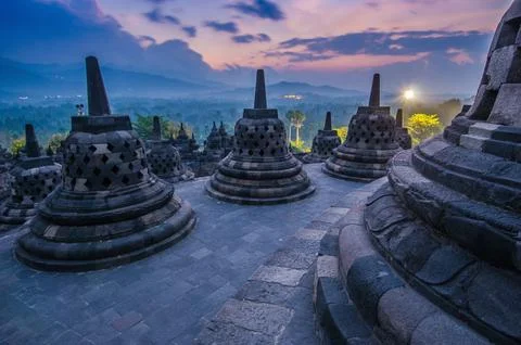 Ancient Buddhist temple during sunset evening time against orange cloudy sky Foto stock