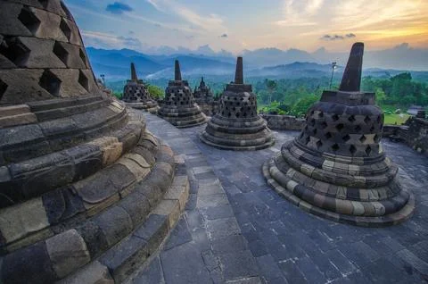 Ancient Buddhist temple during sunset evening time against orange cloudy sky Foto stock