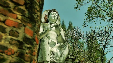 Ancient Buddhist Temple Ruins during the day and a big Buddha statue Stock Footage 247473009