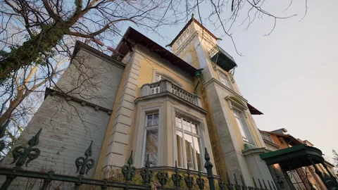 Ancient building with classic windows and balcony on facade under clear sky Stock Footage 319891442