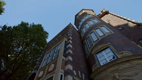 Ancient building facade with golden plaster decorative elements on shady street Stock Footage 314368278