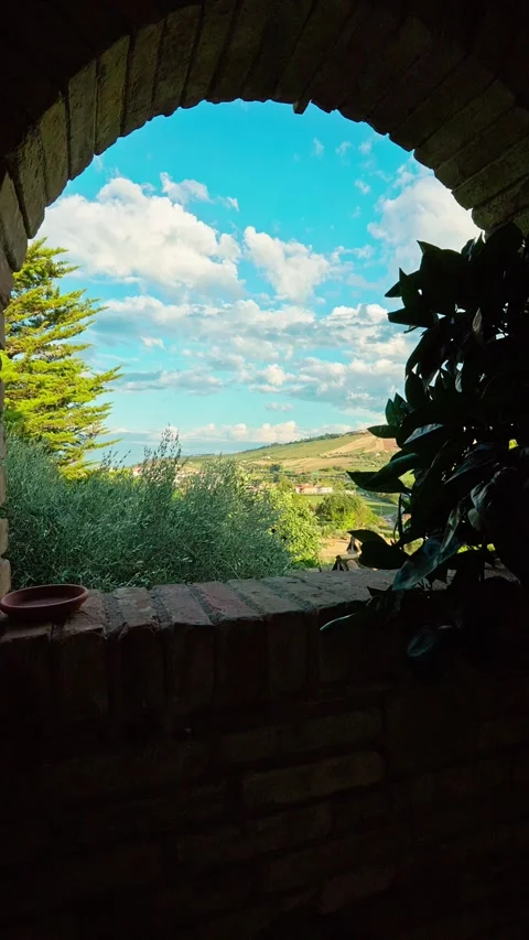 Ancient building window with view over Abruzzo hills and cloudy sky Stock Footage 328003677