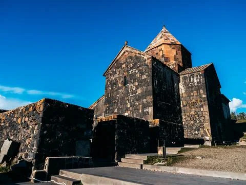 Ancient buildings entrance, Sevanavank Monastery on blue sky background. Stock Photos