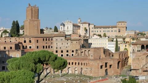 Ancient buildings, pine trees and Colosseum at the sunset in Rome - 4K, Pan Stock Footage 167228614