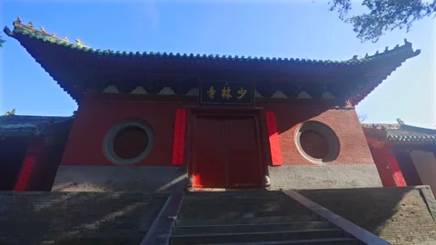 Ancient buildings of Shaolin Monastery with flying pigeons at sunrise, sacred Stock-Footage 344220027
