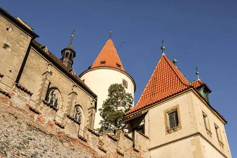 Ancient castle architecture with conical red tiled roofs against a clear bl.. Stock Photos