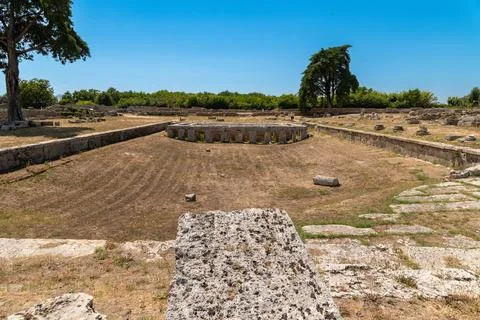 Ancient circular structure and ruins in open field Stock Photos
