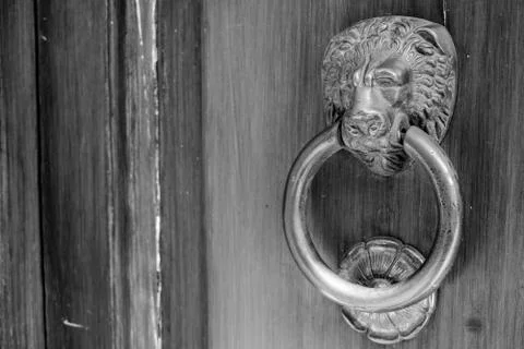 Ancient clapper on an ancient door Stock Photos
