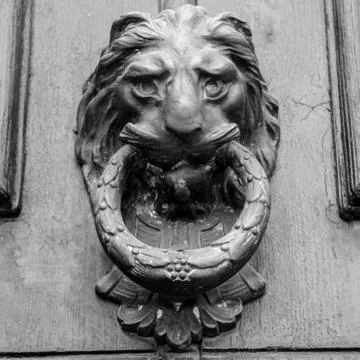 Ancient clapper on an ancient door Stock Photos