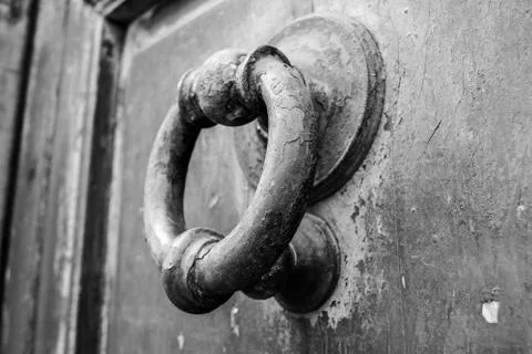 Ancient clapper on an ancient door Stock Photos