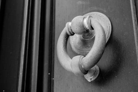 Ancient clapper on an ancient door Stock Photos
