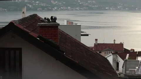 Ancient clay tile rooftops of houses with chimneys and turbo deflector Stock Footage 165078886