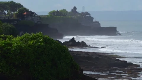 Ancient Cliffside Temple With Lush Foreground And Foggy Horizon Stock Footage 337433268