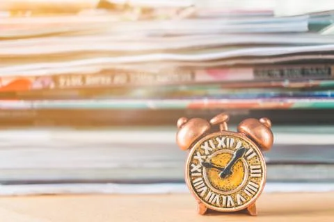 Ancient clock and stack of book Stock Photos