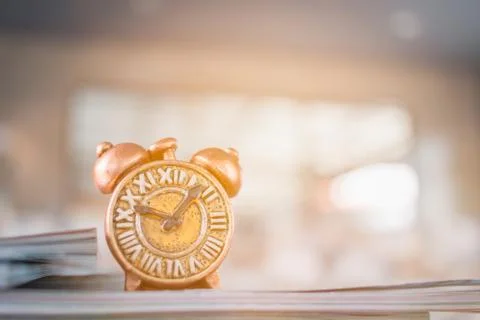 Ancient clock and stack of book 写真素材