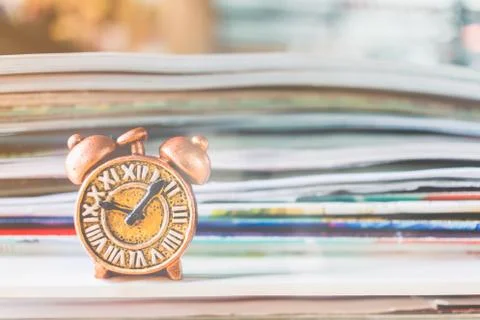Ancient clock and stack of book 写真素材