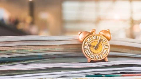 Ancient clock and stack of book 写真素材