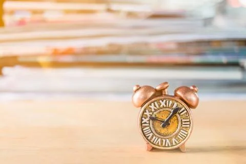 Ancient clock and stack of book Stock Photos