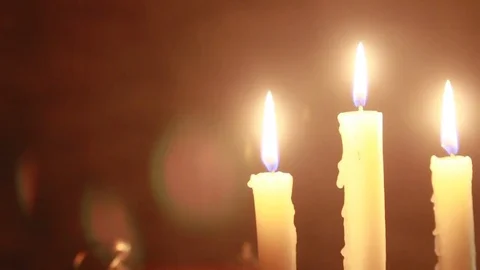 Ancient clock and three candles on a candlestick Stock Footage 84618703