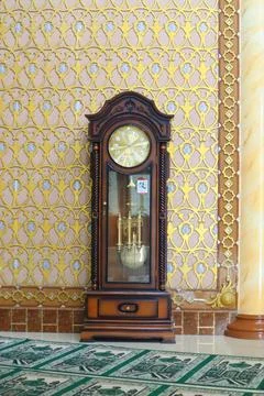 An ancient clock on display in a building Stock Photos