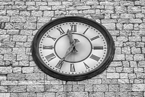 Ancient clock on a stone tower in Assisi, Italy Stock Photos