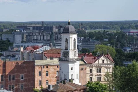 The ancient Clock Tower in the cityscape on a June day. Vyborg, Russia Stock Photos