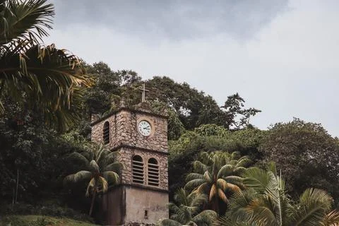 Ancient clock tower in the town in the middle of the forest Stock Photos