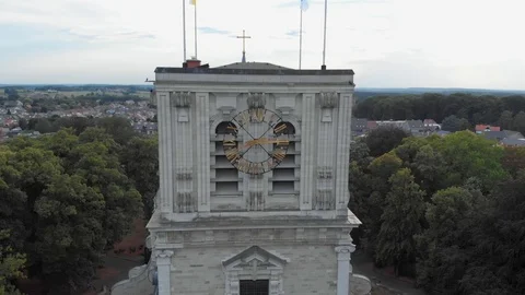 Ancient clocks on cathedrals with flags on in belgium flying around drone Video stock 123150500