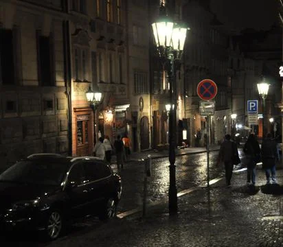 Ancient cobblestone pavement in Prague during a night summer rain. Stock Photos
