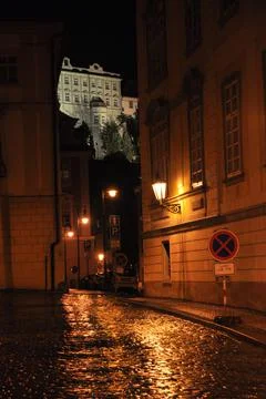 Ancient cobblestone pavement in Prague during a night summer rain. Stock Photos