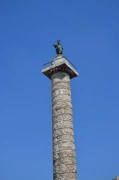 Ancient column of Marcus Aurelius with a helix relief a bronze statue of th.. Stock Photos