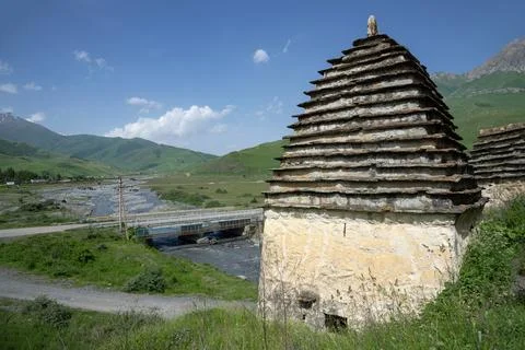 An ancient crypt over a mountain river. The city of the dead is Dargavs Stock Photos