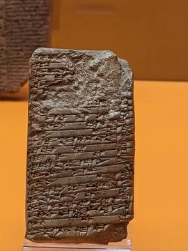 Ancient cuneiform tablet displayed in museum exhibit Stock Photos