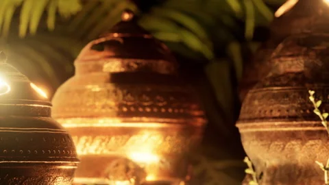 Ancient decorative pots showcased in a lit garden at night Stock Footage 337872629