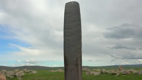 Ancient deer stone stele in grassy steppe - Balbal Stele and Burial Marker Stock Footage 340608705