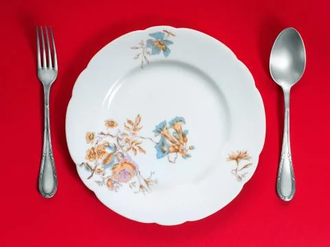 Ancient dinner set on red background Foto stock